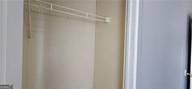 a bathroom with a toilet and a mirror