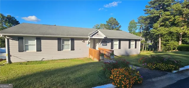 a view of a backyard with wooden fence