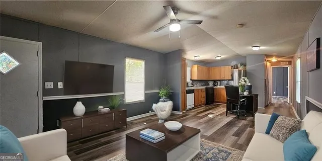 a living room with furniture and a flat screen tv