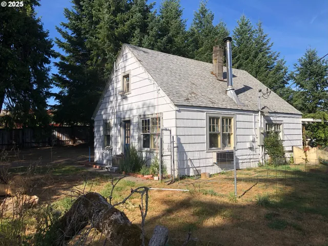 a view of a house with pool and sitting area