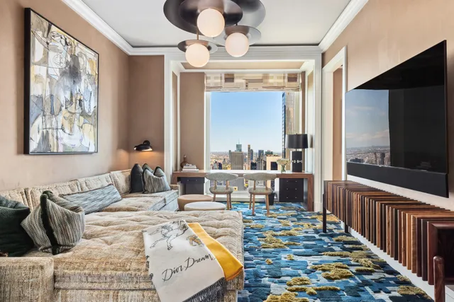 a large kitchen with stainless steel appliances granite countertop a lot of cabinets and wooden floor