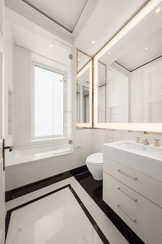 a bedroom with furniture and a large window