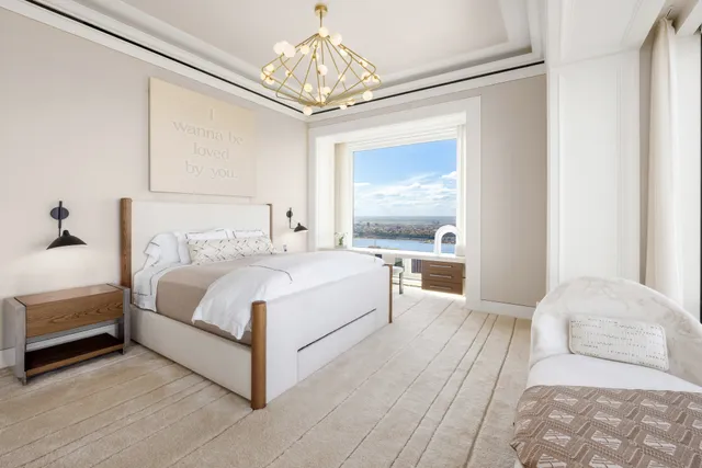 a bedroom with bed and large windows