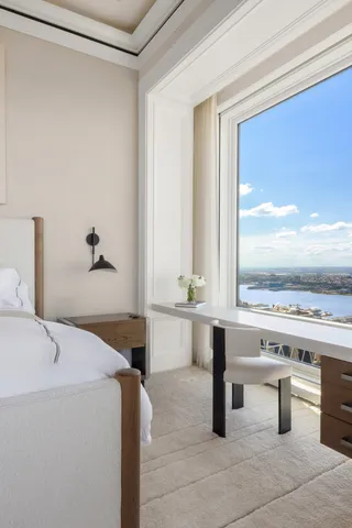 a bedroom with a large bed and a chandelier