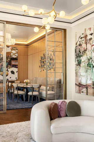 a living room with furniture and a chandelier