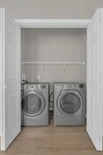 a utility room with sink dryer and washer