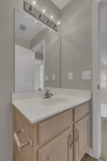 a bathroom with a sink vanity and a mirror