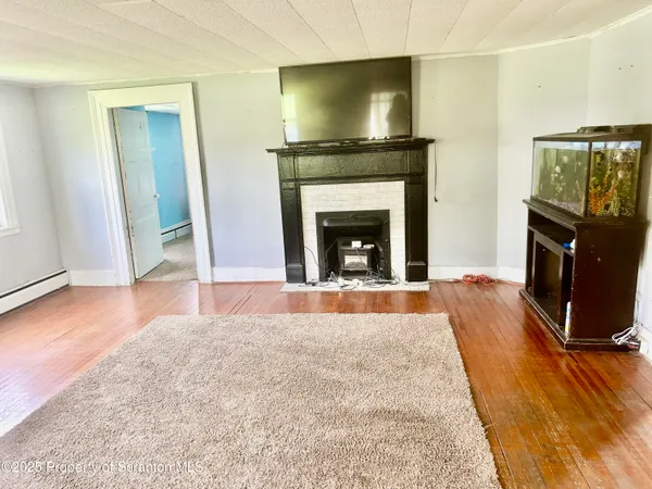 a living room with a fireplace and a flat screen tv