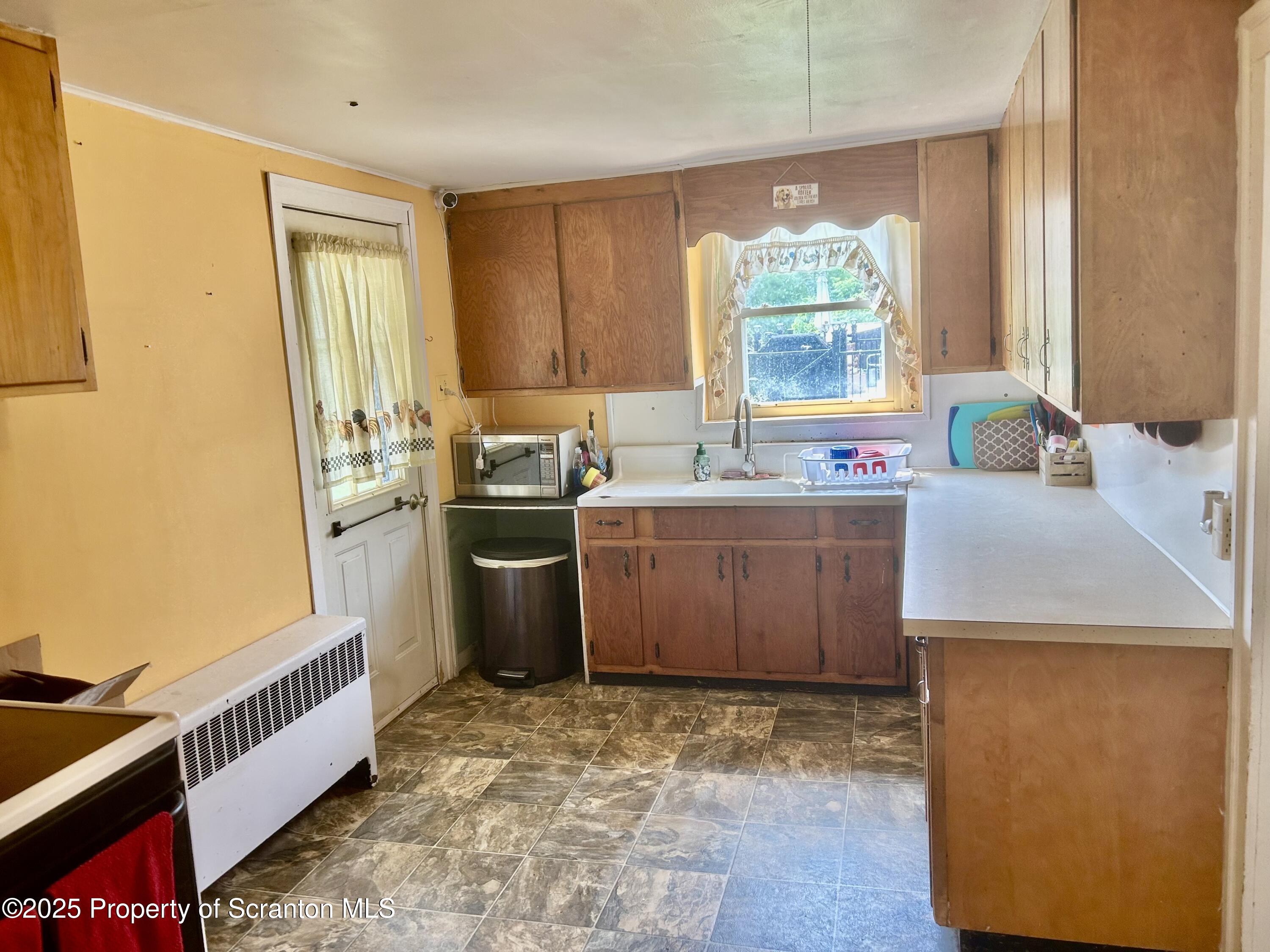 536 Old Rte 11 New Milford, PA 18834 - Photo 7 of 36 a kitchen with a sink stove and cabinets