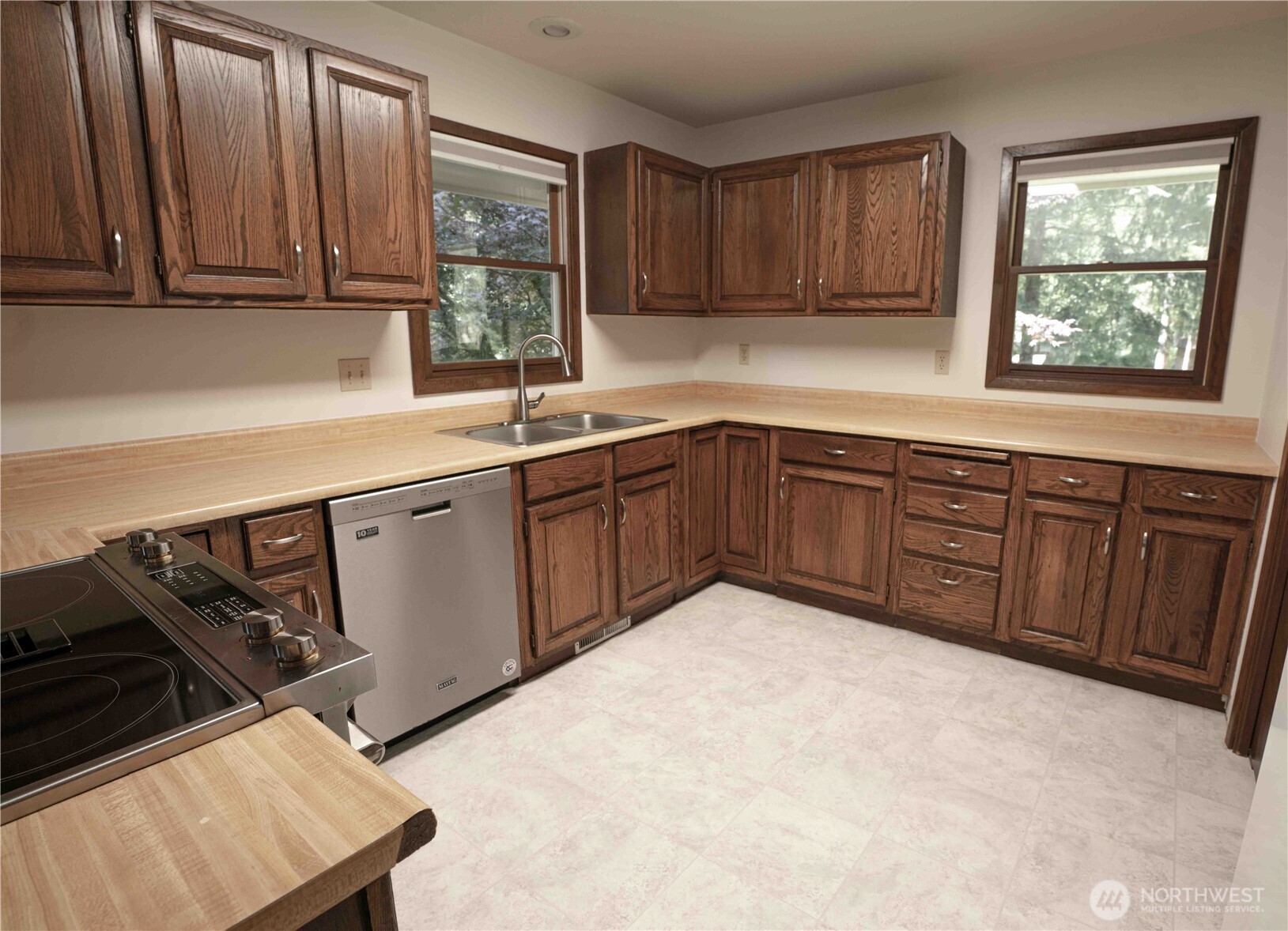 293154 Highway 101 Quilcene, WA 98376 - Photo 11 of 40 a kitchen with a sink wooden cabinets and a window