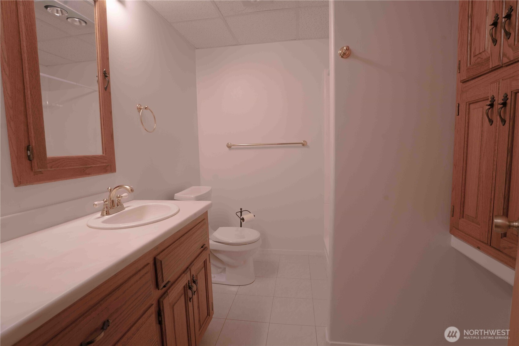 293154 Highway 101 Quilcene, WA 98376 - Photo 22 of 40 a bathroom with a sink a toilet and mirror