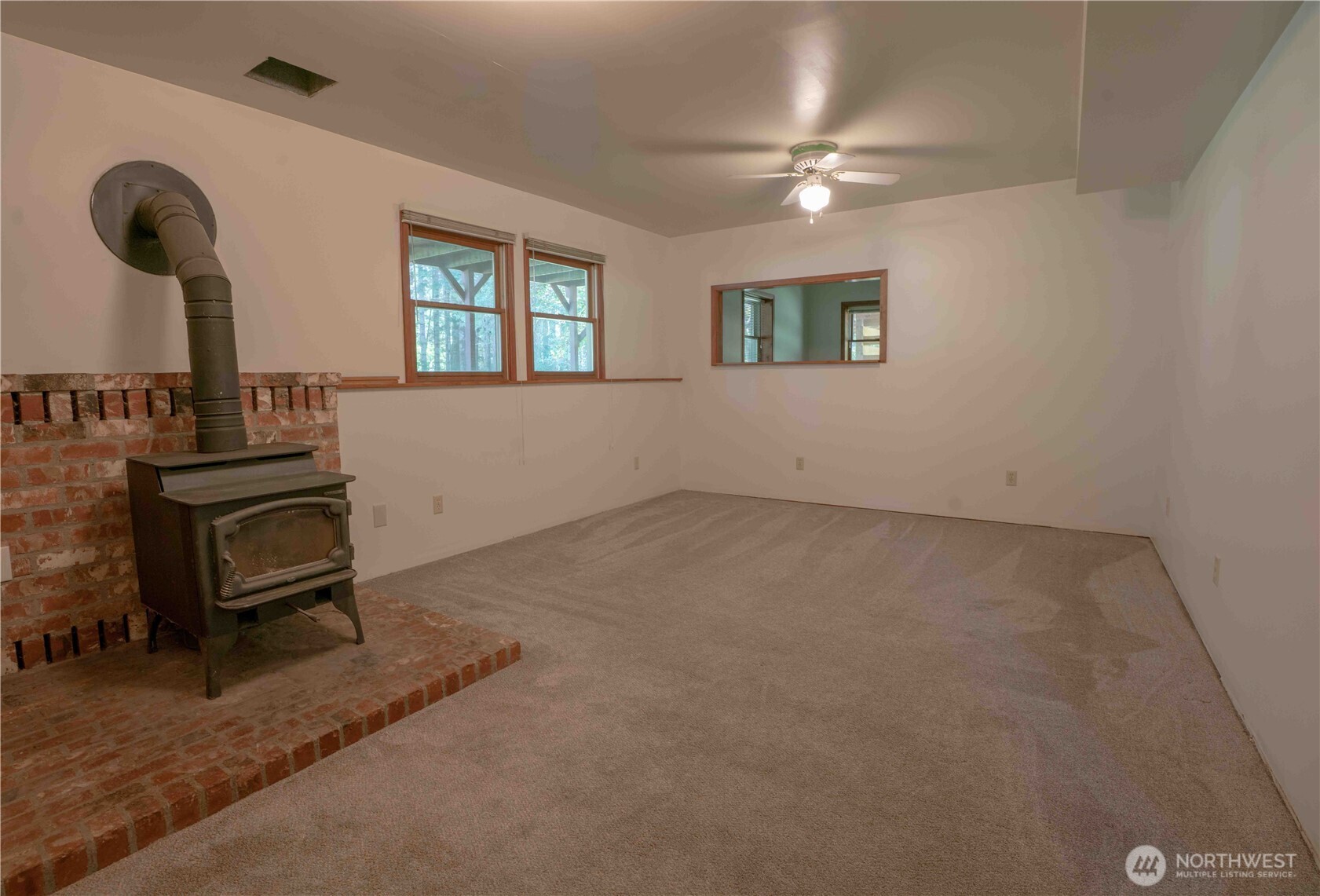 293154 Highway 101 Quilcene, WA 98376 - Photo 23 of 40 a view of empty room with windows