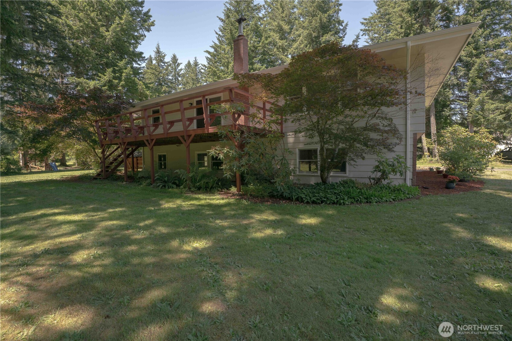 293154 Highway 101 Quilcene, WA 98376 - Photo 32 of 40 a view of a house with a yard
