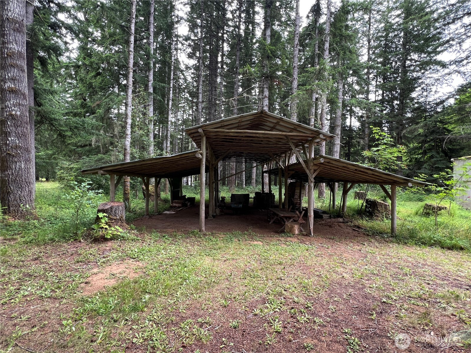 293154 Highway 101 Quilcene, WA 98376 - Photo 34 of 40 a view of a table and chairs under an umbrella