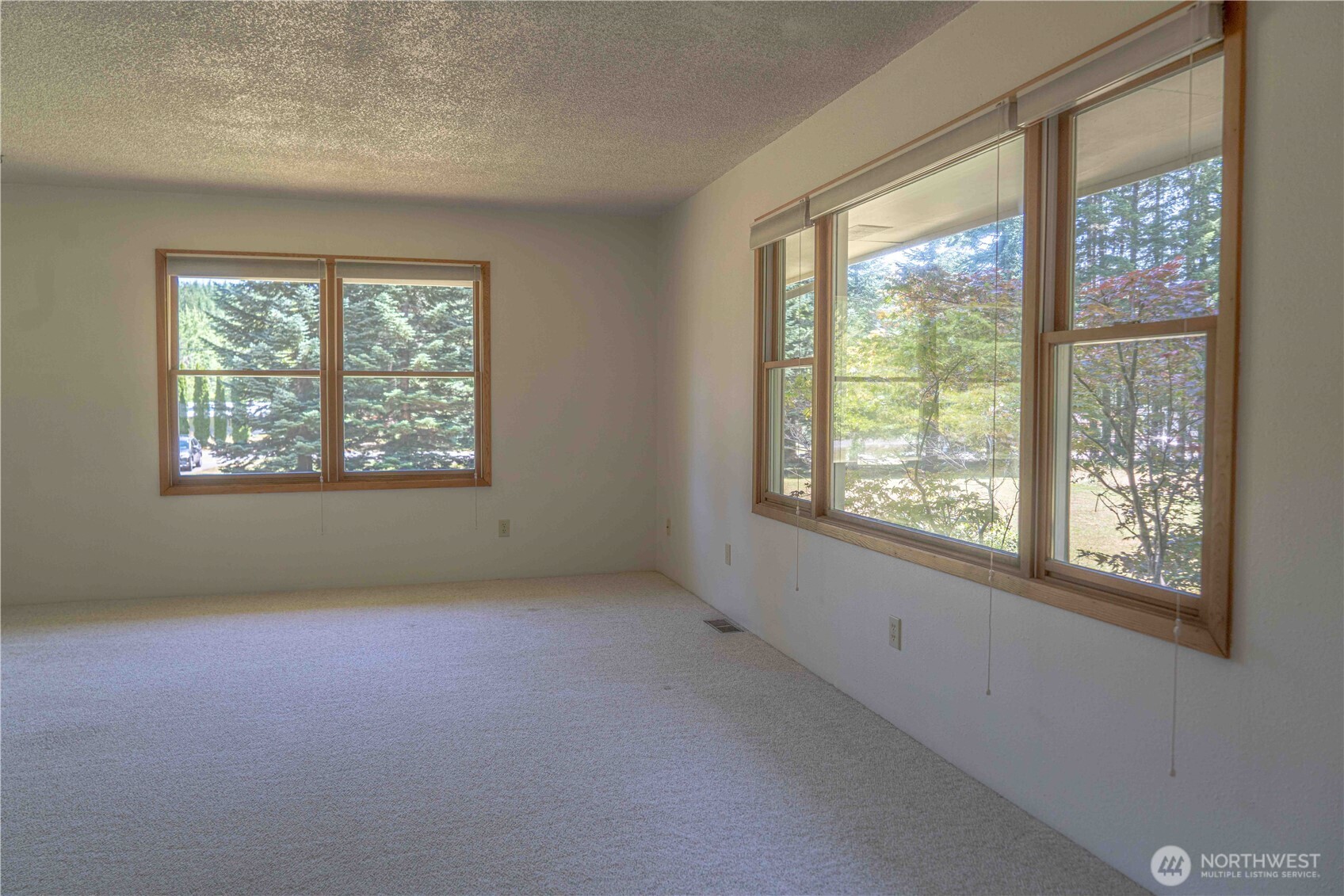 293154 Highway 101 Quilcene, WA 98376 - Photo 6 of 40 an empty room with windows
