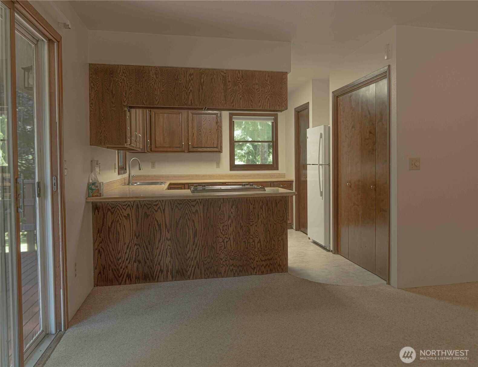 293154 Highway 101 Quilcene, WA 98376 - Photo 7 of 40 a kitchen with kitchen island a sink stainless steel appliances and cabinets