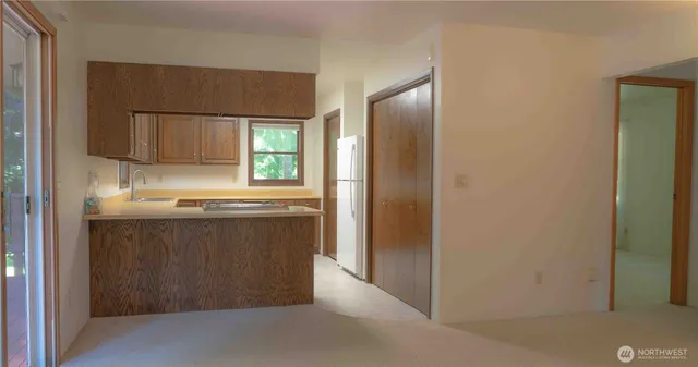 a kitchen with stainless steel appliances granite countertop a sink and a stove