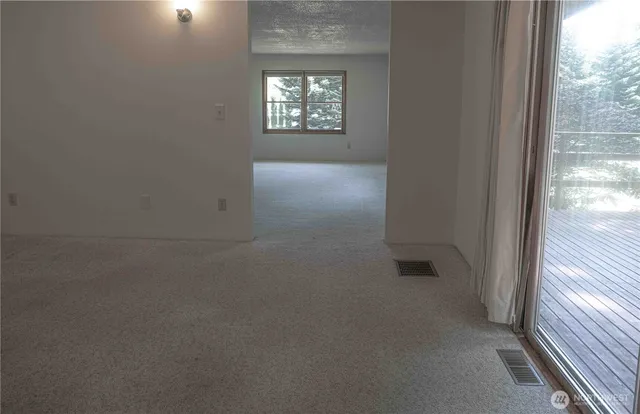 a kitchen with a sink wooden cabinets and a window