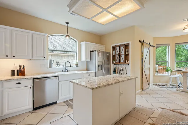 a kitchen with stainless steel appliances granite countertop a sink and cabinets
