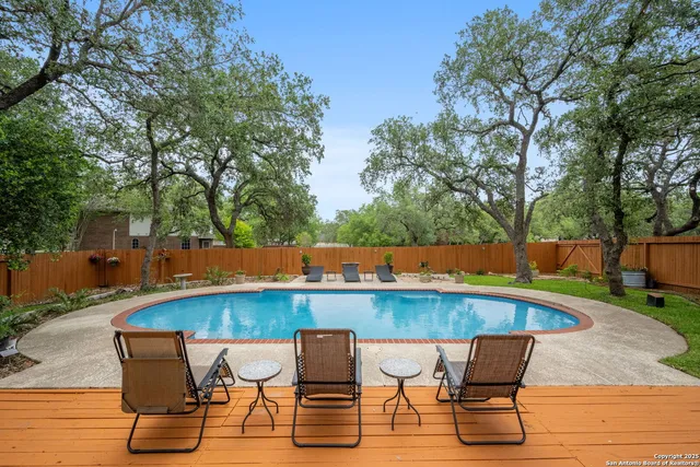 an outdoor sitting area with furniture and wooden deck