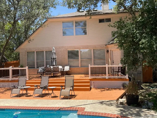 a house view with swimming pool and sitting space