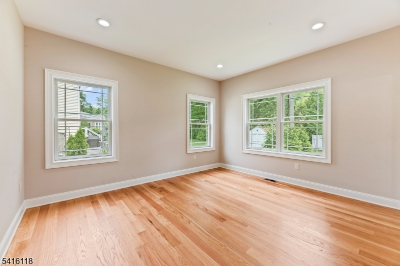 118 Cambridge Road Westfield, NJ 07090 - Photo 20 of 50 a view of an empty room with wooden floor and a window