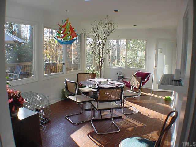 3905 Lancaster Drive Raleigh, NC 27612 - Photo 1 of 1 a dining room with furniture a rug and a chandelier