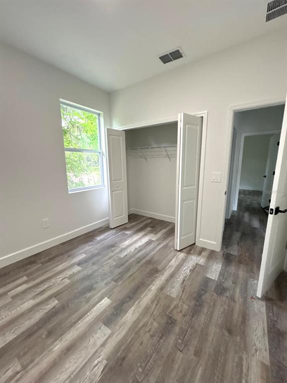 1683 Southwest 3rd Street Ocala, FL 34471 - Photo 13 of 14 a view of a livingroom with wooden floor and a window