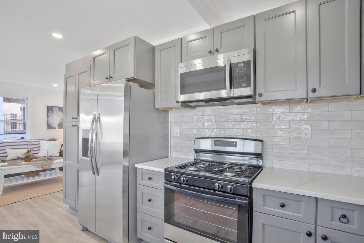 a kitchen with stainless steel appliances and cabinets