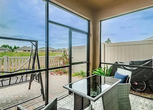 a dining room with furniture and a potted plant