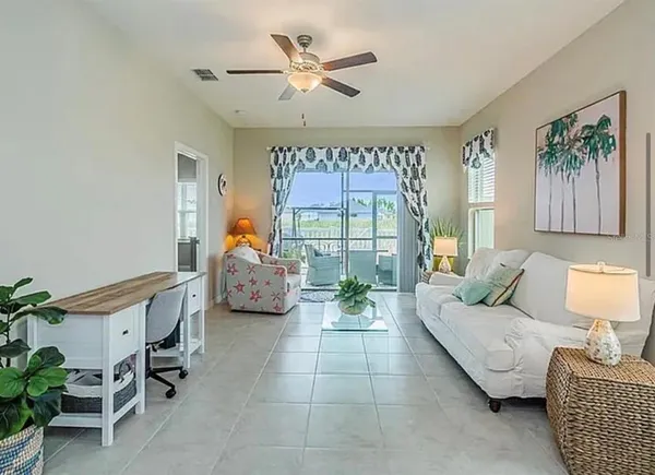 a living room with furniture a table and a potted plant