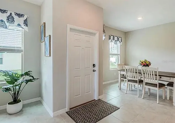 a dining room with furniture and window