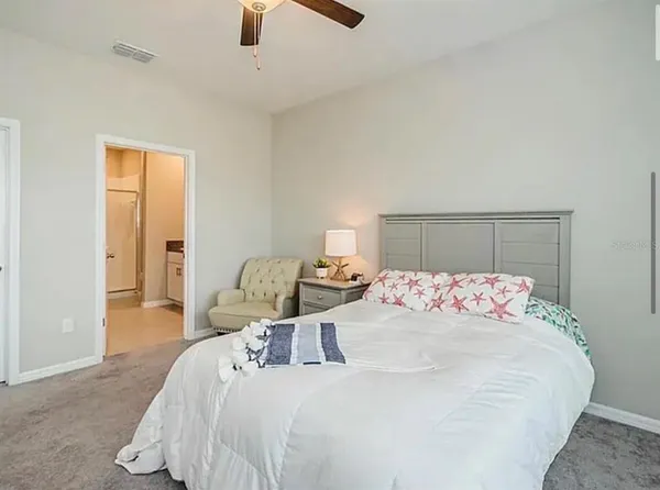 a bedroom with a bed and window