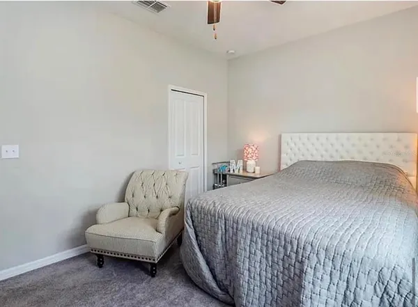 a bedroom with a bed and a couch