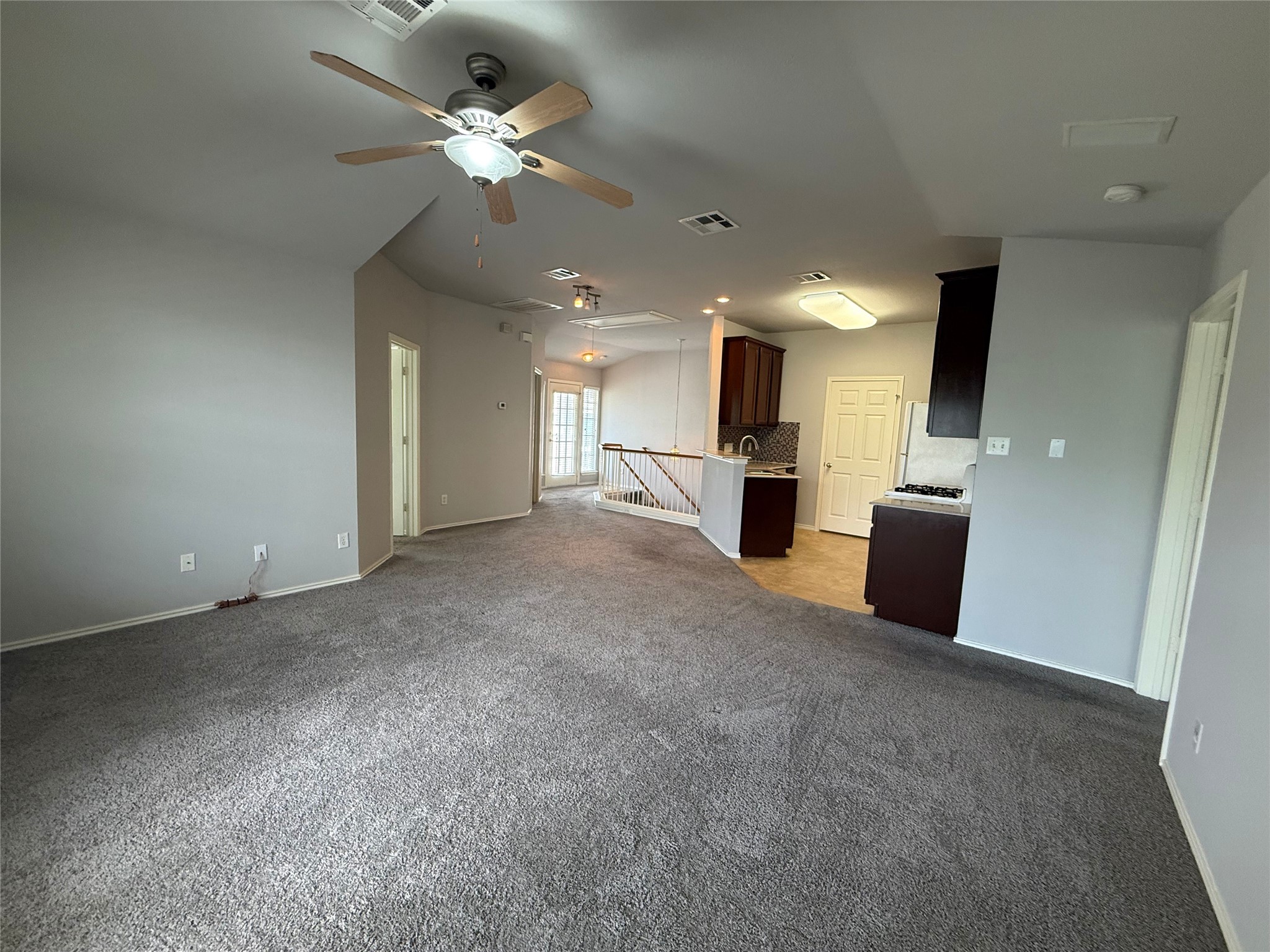 1900 Scofield Ridge Parkway, Unit 4701 Austin, TX 78727 - Photo 5 of 27 An inviting open-concept living area with plush carpeting flows into a well-appointed kitchen.