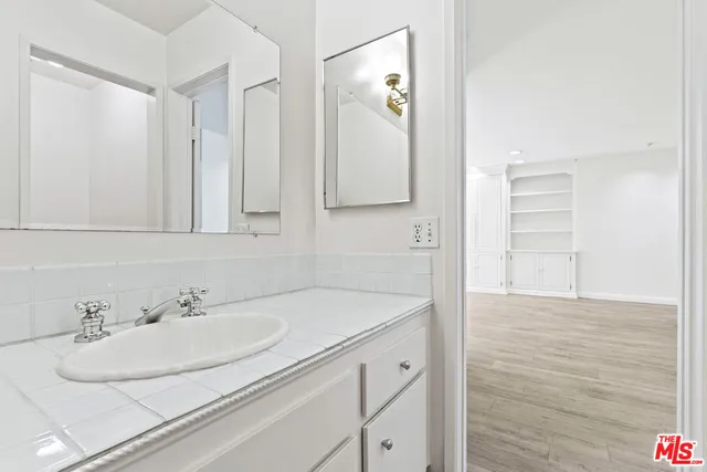 a bathroom with a shower and vanity