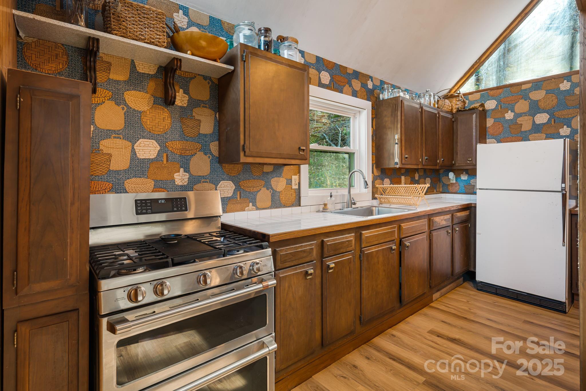 1877 Secluded Valley Road Marshall, NC 28753 - Photo 14 of 31 a kitchen with a stove a sink and a refrigerator