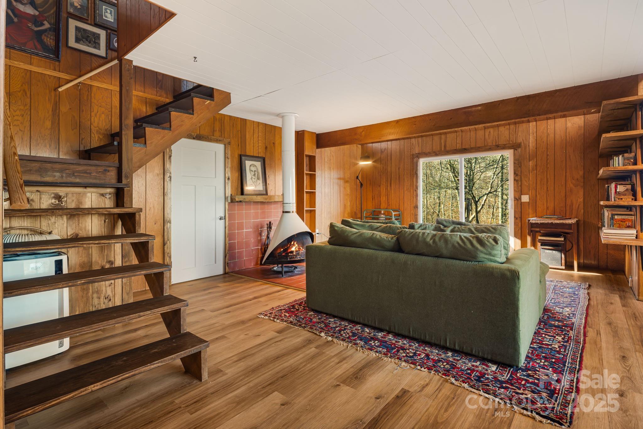 1877 Secluded Valley Road Marshall, NC 28753 - Photo 16 of 31 a living room with furniture and a book shelf