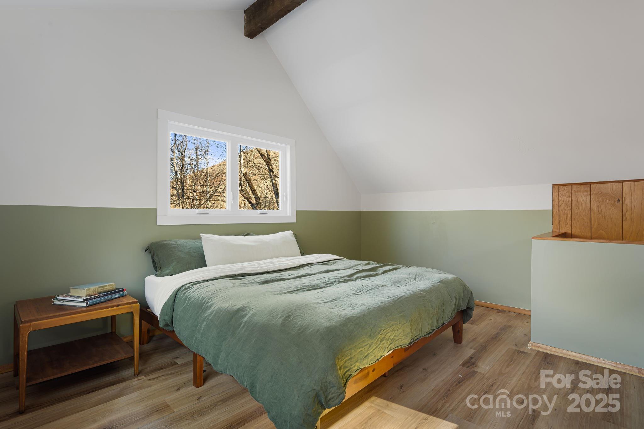 1877 Secluded Valley Road Marshall, NC 28753 - Photo 21 of 31 a bedroom with a bed and a wall painting