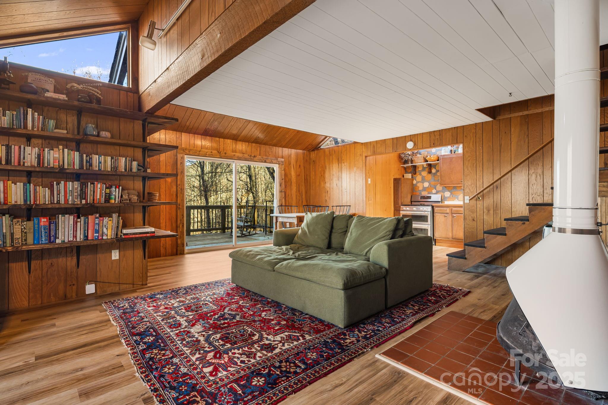 1877 Secluded Valley Road Marshall, NC 28753 - Photo 7 of 31 a living room with furniture a rug and a book shelf