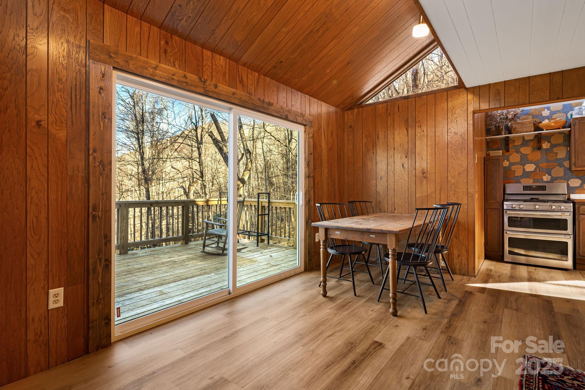 1877 Secluded Valley Road Marshall, NC 28753 - Photo 9 of 31 a view of a dining room with furniture and wooden floor