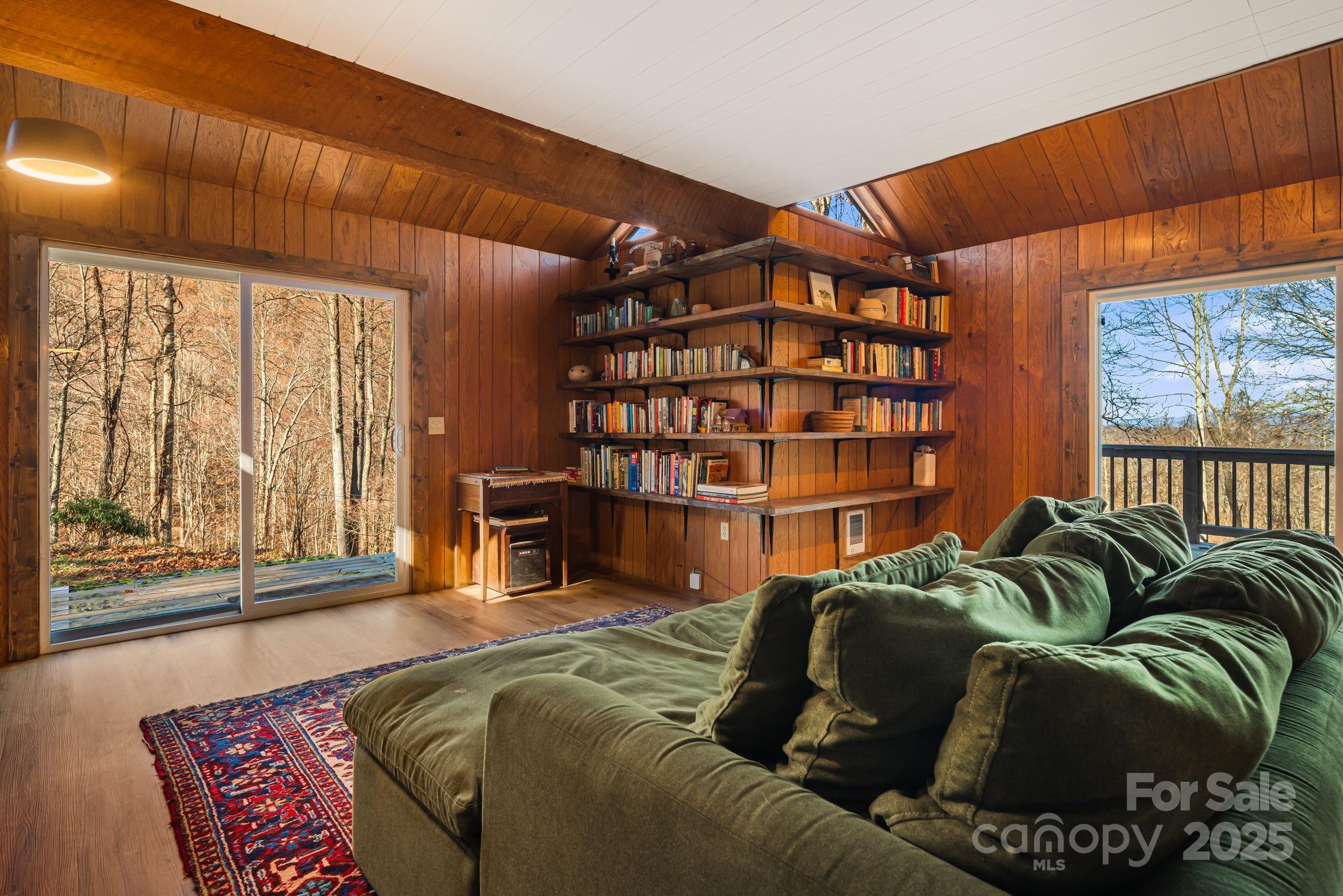 1877 Secluded Valley Road Marshall, NC 28753 - Photo 10 of 31 a living room with furniture a large window and bookshelf