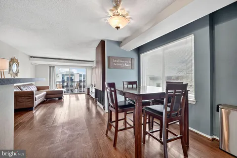 a view of a dining room with furniture window and wooden floor