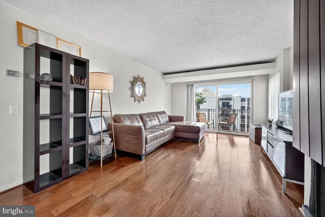 a living room with furniture fireplace and wooden floor