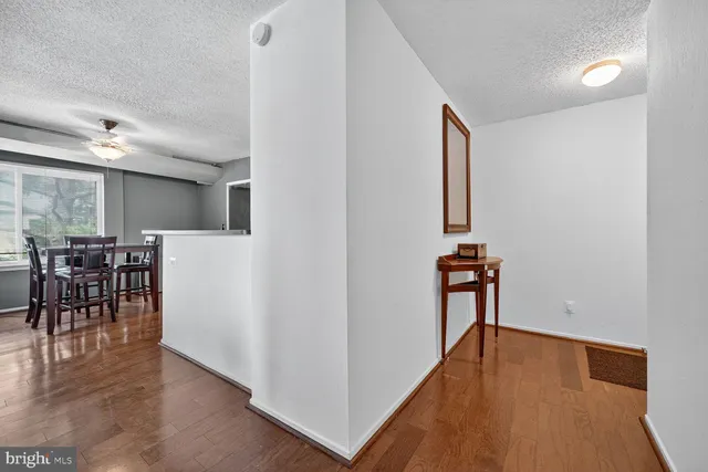 a view of a room with furniture and wooden floor