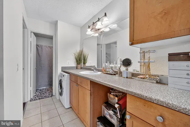 a kitchen with a sink and a mirror