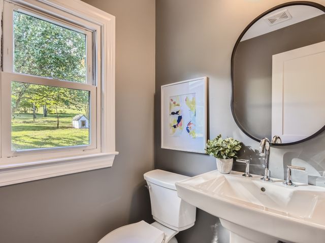 a bathroom with a toilet a sink and a mirror