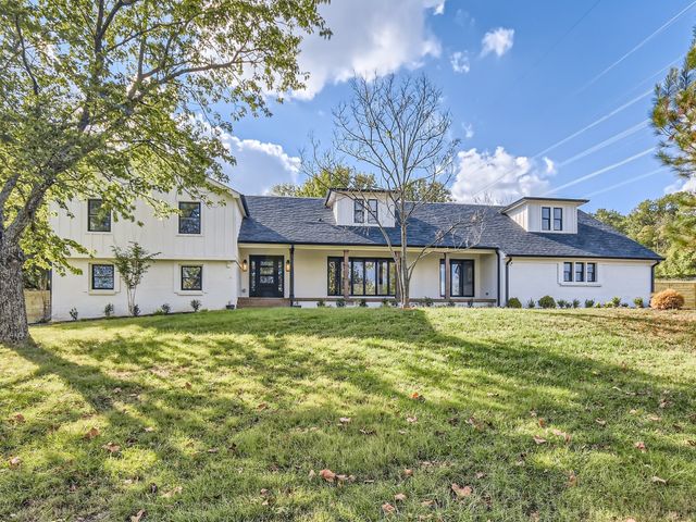 a large tree in front of a house