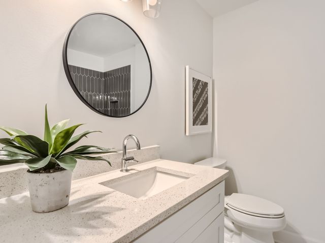 a bathroom with a sink a mirror and a toilet