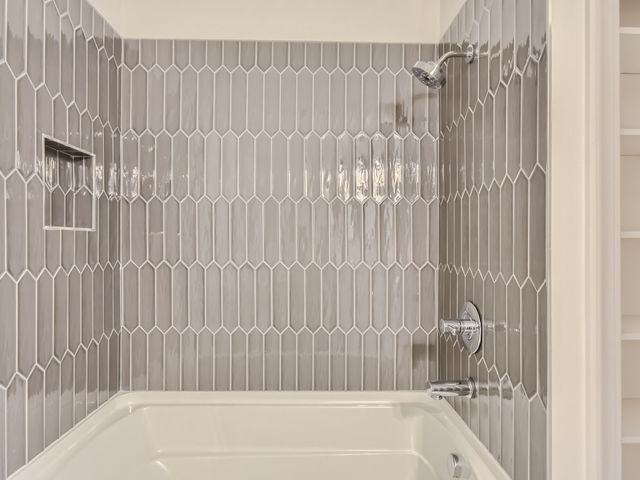 a bathroom with bathtub and shower